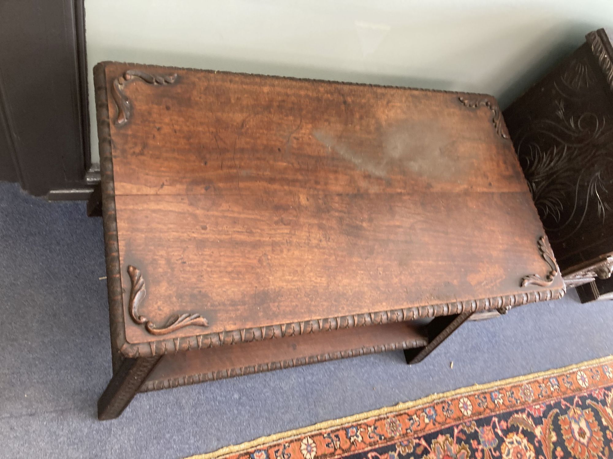 A rectangular carved hardwood two tier table, width 90cm, depth 56cm, height 64cm